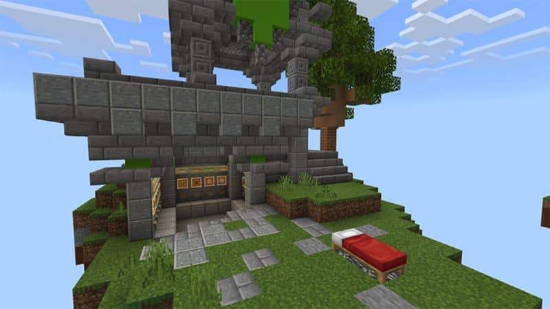 red bed and house on hill in minecraft